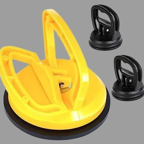 Yellow suction cup tool with two black handles on a gray background